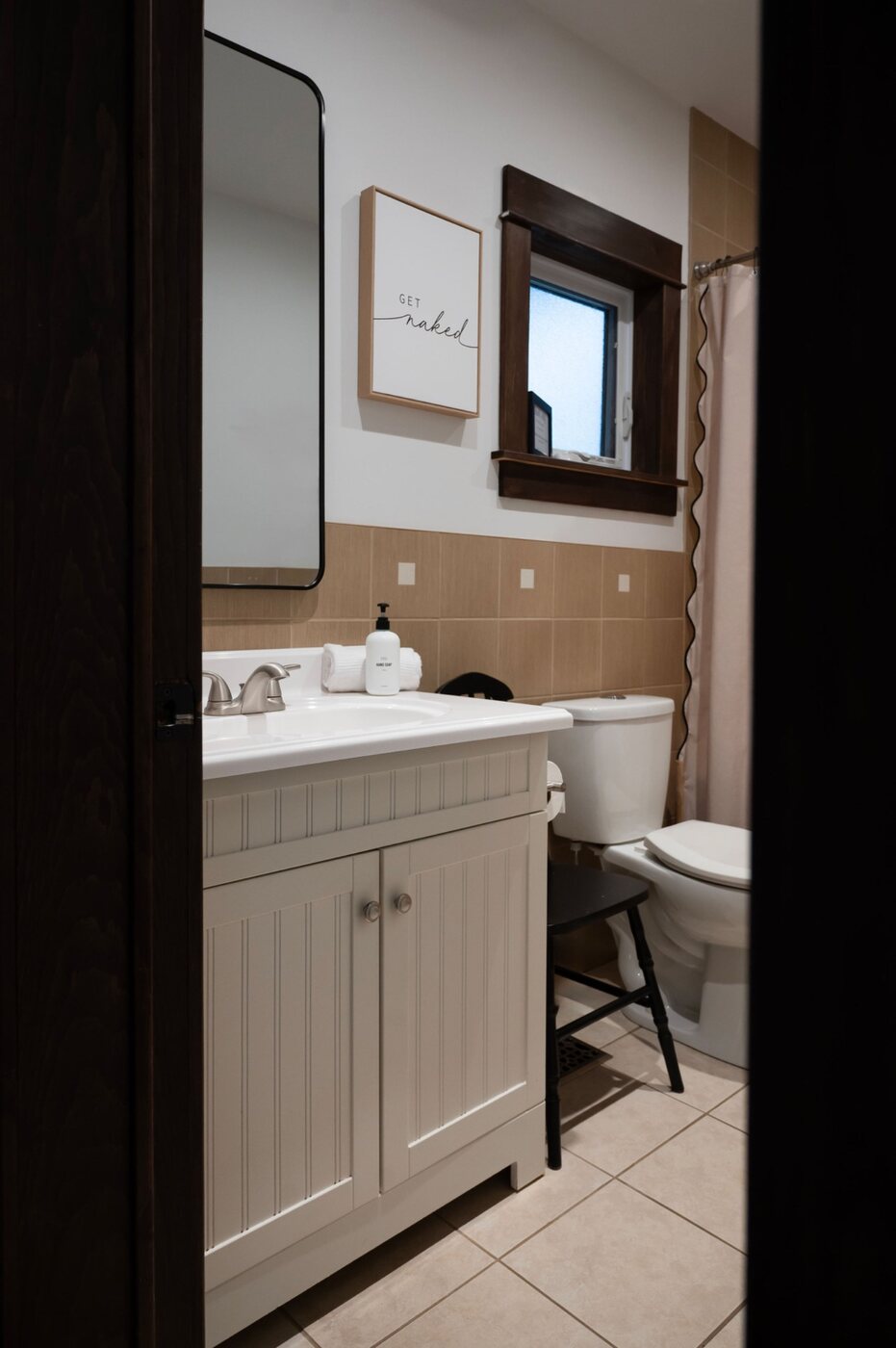 Bright cottage bathroom with vanity and shower