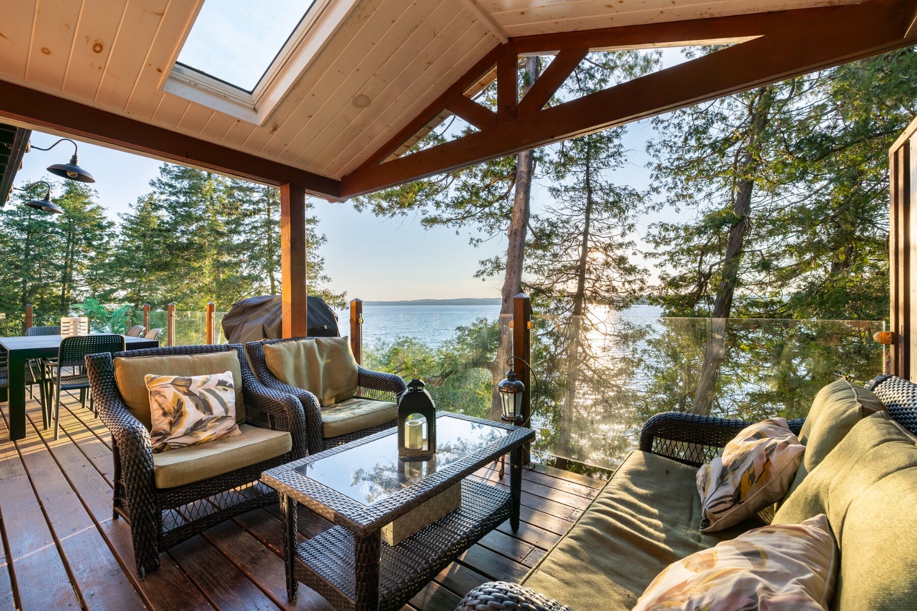 Covered lakefront deck at Rice Lake Treehouse overlooking Rice Lake at sunset